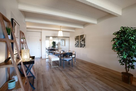 a living room and dining room with a table and chairs